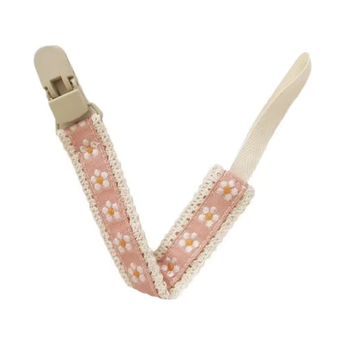 Attache tétine en tissu rose, motif marguerites blanches