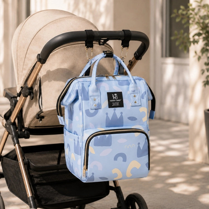 Sac à dos à langer bébé Harry Baby motif royaux tenu par les poignées