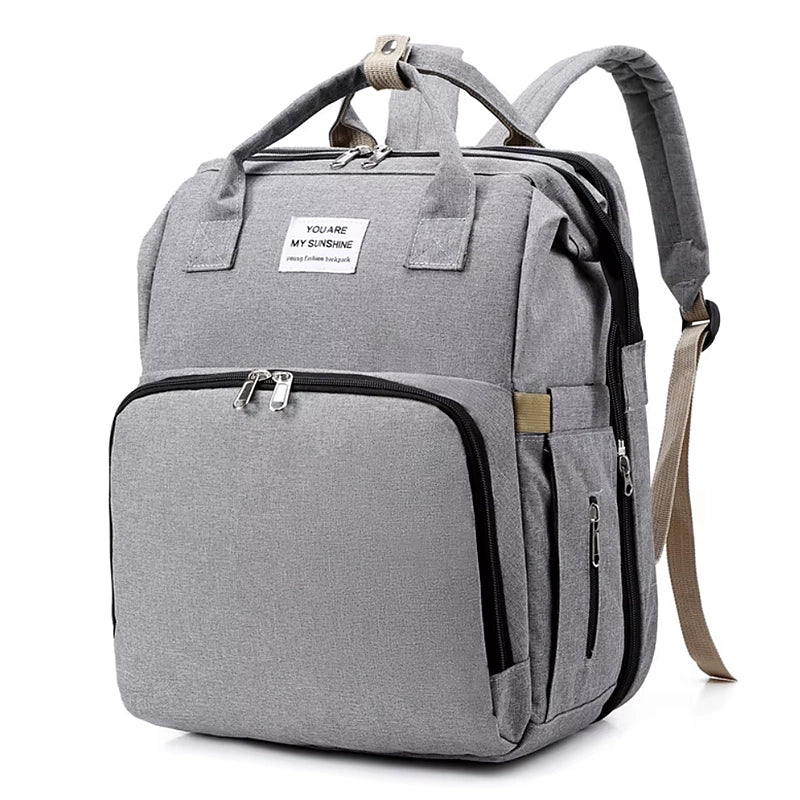 Sac à langer 3 en 1 convertible en lit bébé gris, vue de trois-quarts