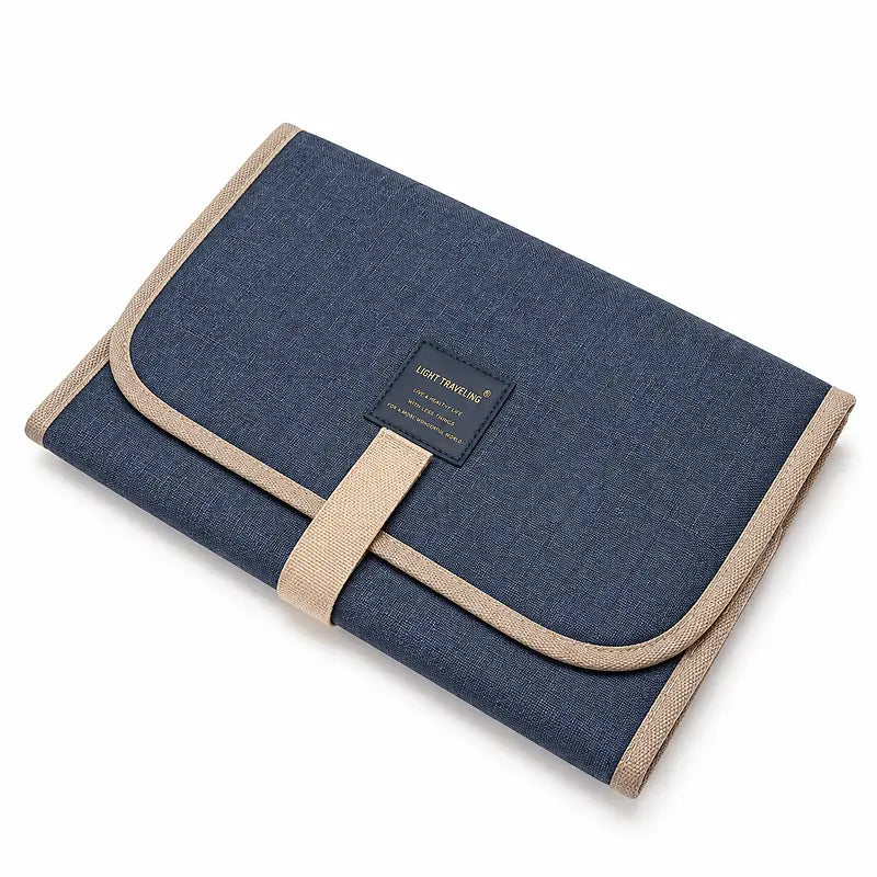 Tapis de change bébé nomade plié bleu marine avec sangle de fermeture, format compact voyage